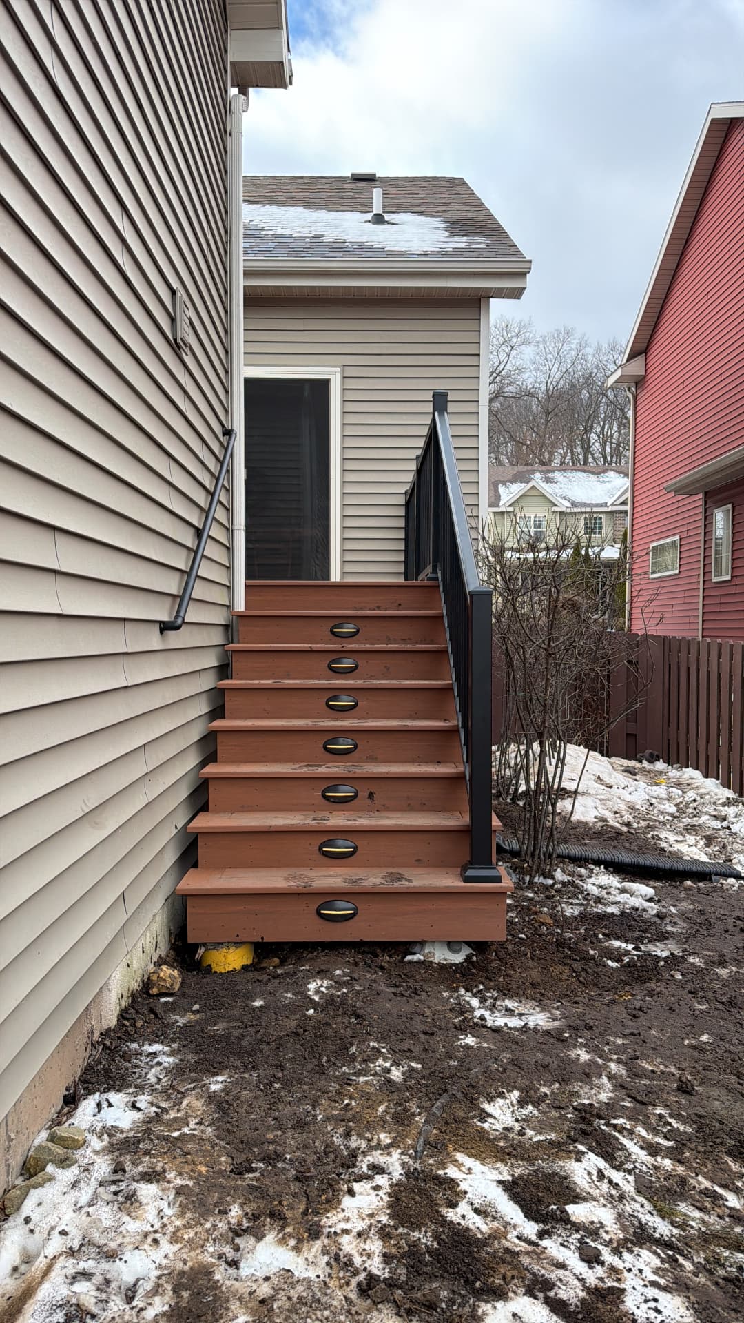 Restored composite entry stairs with integrated LED lighting and black handrail in Dane County WI