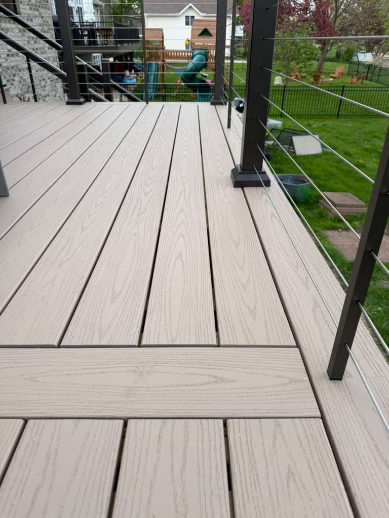 Close-up of light grey picture-framed PVC and composite deck boards